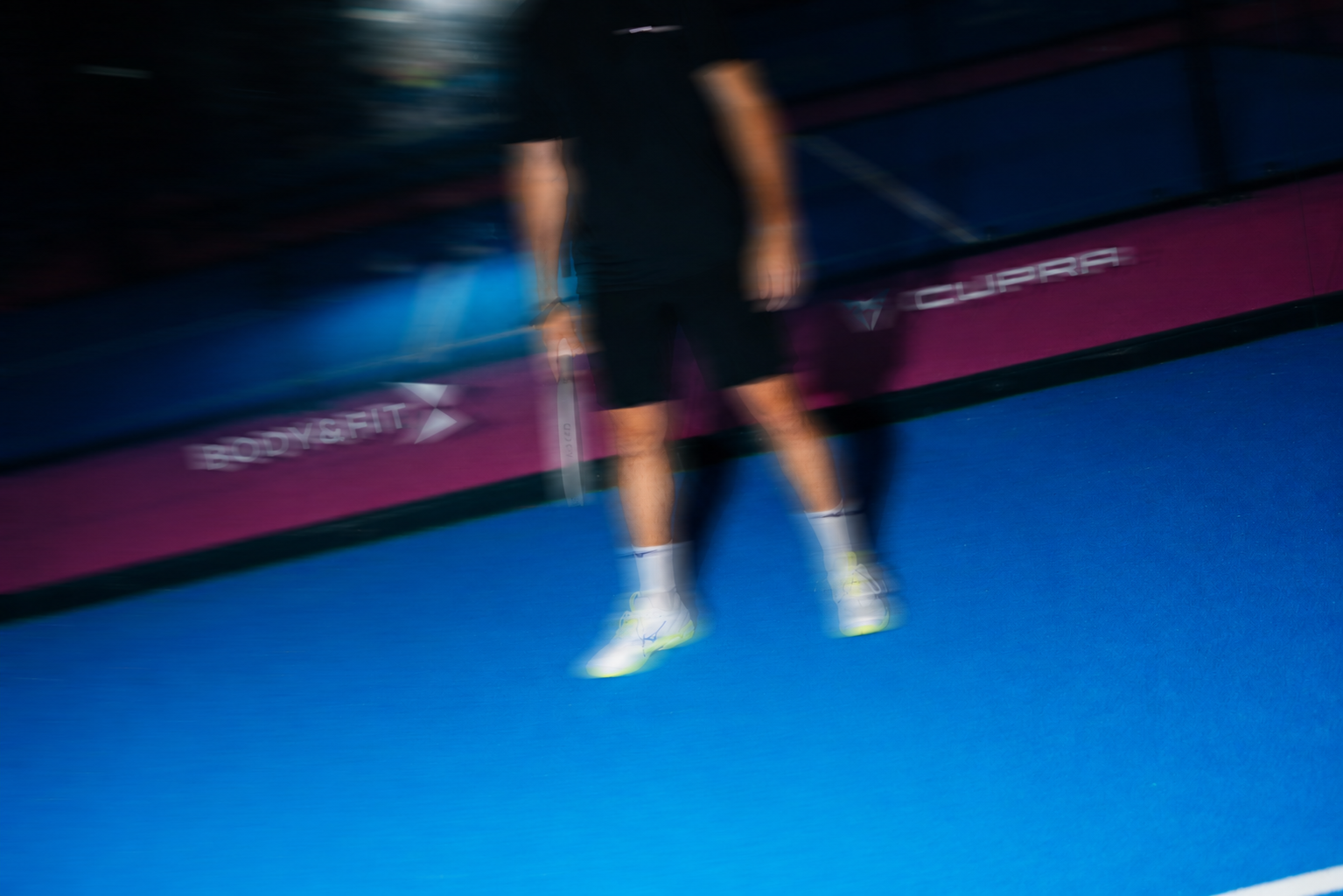 Colleagues touching rackets on court